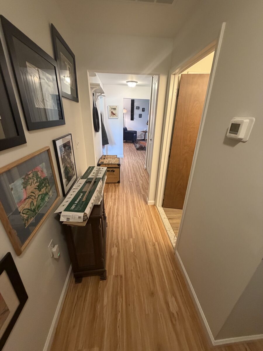 Hallway with finished hardwood flooring running its length