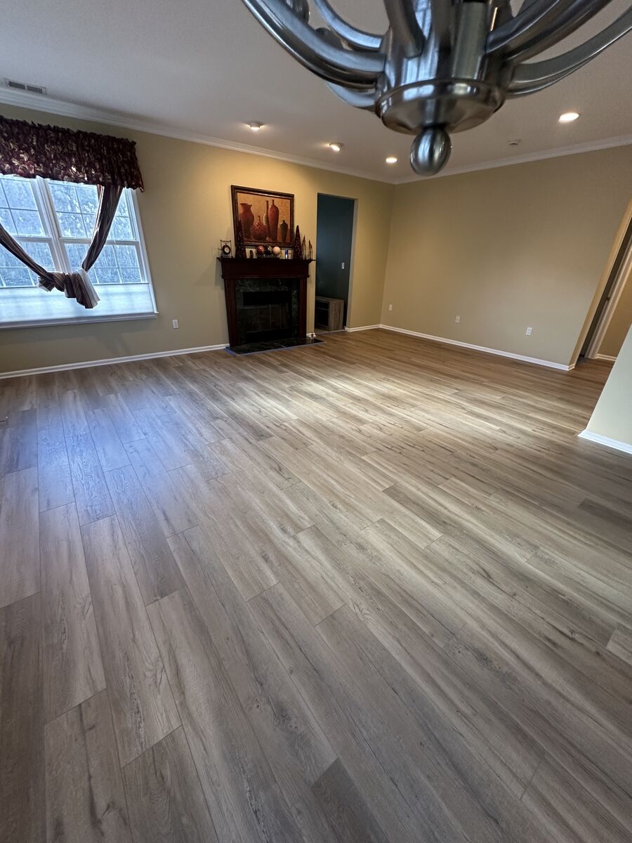 Living room with fireplace and newly installed hardwood floor