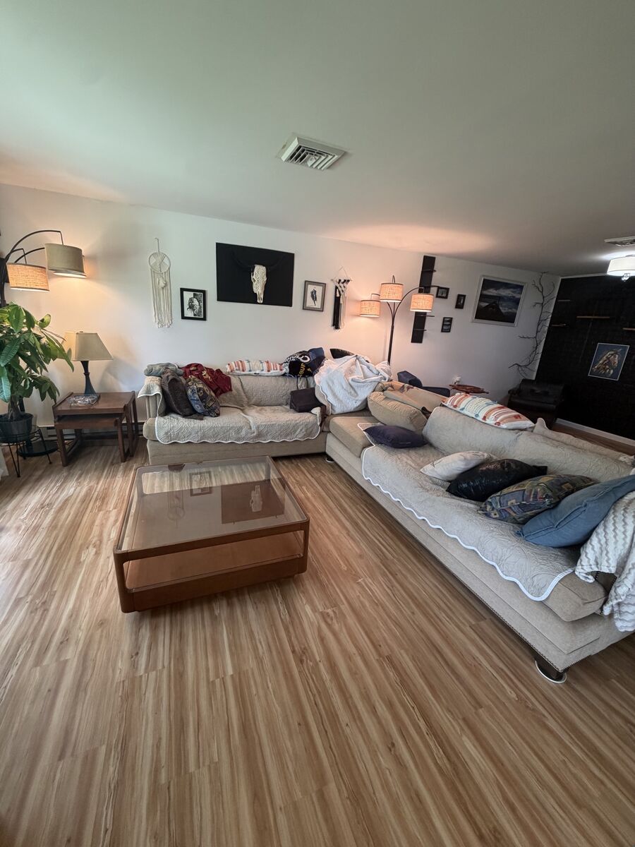 Living room with sectional sofa on finished flooring