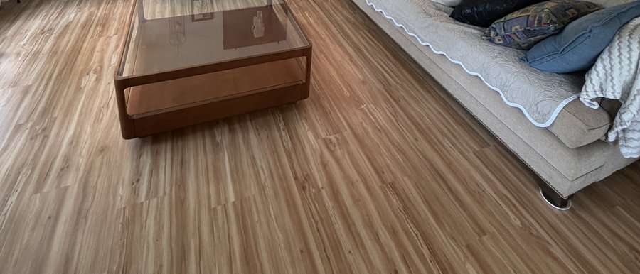 Same living room after Oak Flooring installed wood-look luxury vinyl plank flooring