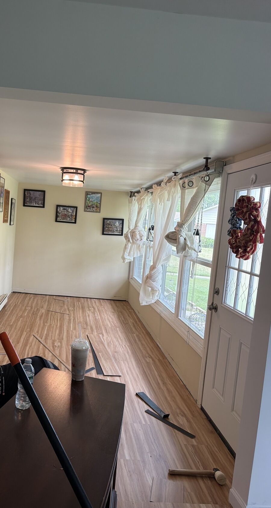 Crew member fitting flooring planks in place on site